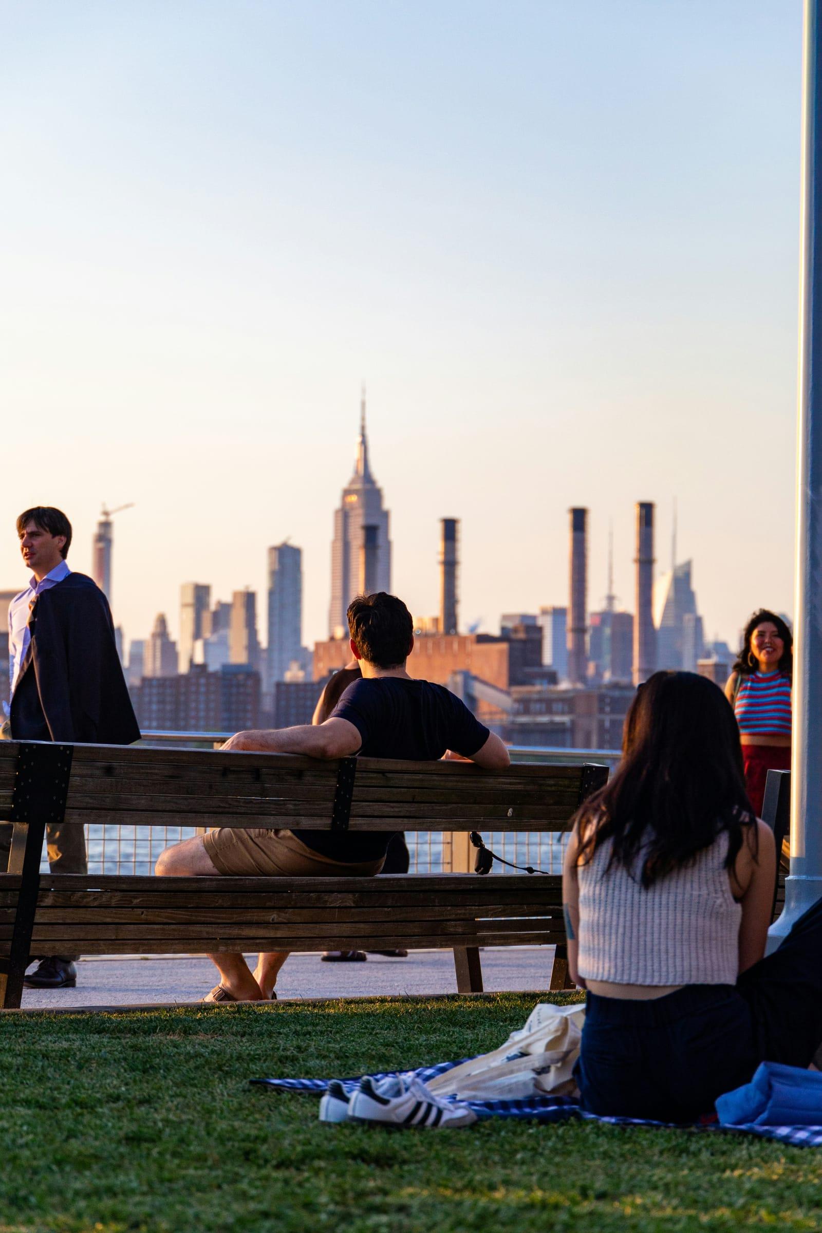 Students at the Brooklyn waterfront with the Manhattan skyline